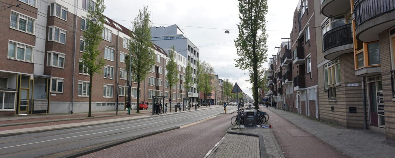a city street lined with tall brick buildings
