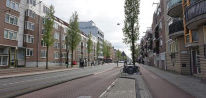a city street lined with tall brick buildings