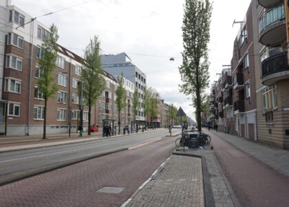 a city street lined with tall brick buildings